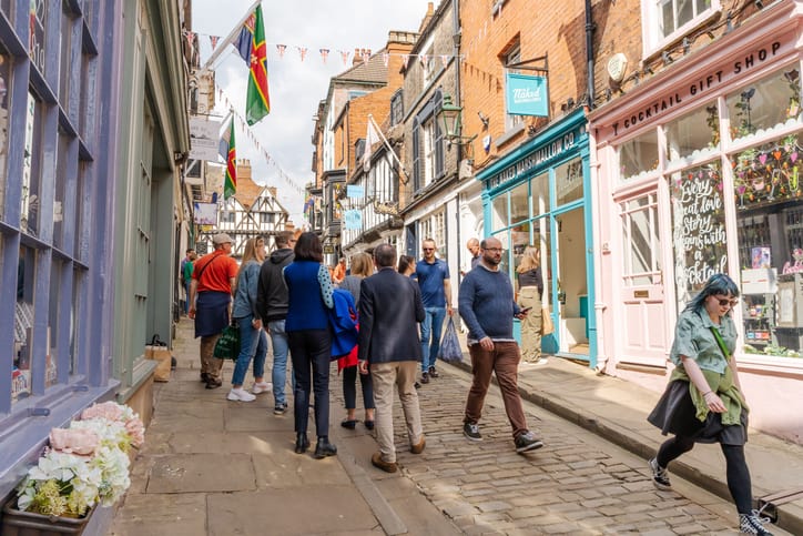 Supporting Independent Retailers | Busy cobbled high street.
